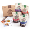 Bags of Doudlah Farms organic beans, like black, pink, cranberry, and navy beans, are displayed in front of a branded cardboard box. Coolbeans recipe cards featuring colorful dishes are also shown, making it a perfect gift box for culinary enthusiasts.