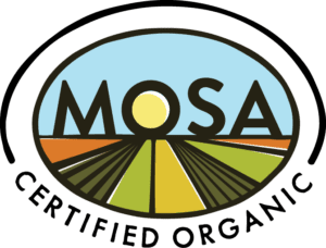 Logo with the word MOSA above a stylized sun and farm landscape. The landscape features green and orange fields with the sun positioned between the letters O and S. The overall shape is an oval.