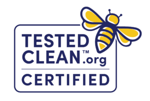 Logo featuring a yellow and blue bee above the text TESTED CLEAN.org CERTIFIED in bold blue letters on a white background, symbolizing our commitment to going beyond organic standards.