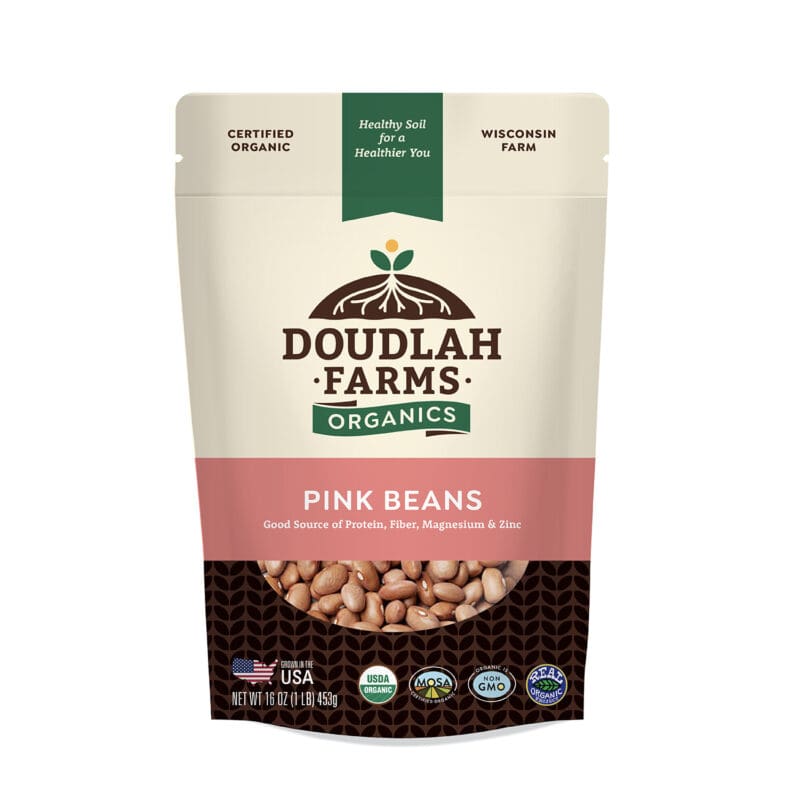 A beige and transparent 1LB bag of Doudlah Farms Organics pink beans, labeled as organic, non-GMO, and gluten-free. The packaging highlights its nutritional benefits, including protein, fiber, magnesium, and zinc. Made in the USA from a Wisconsin farm.