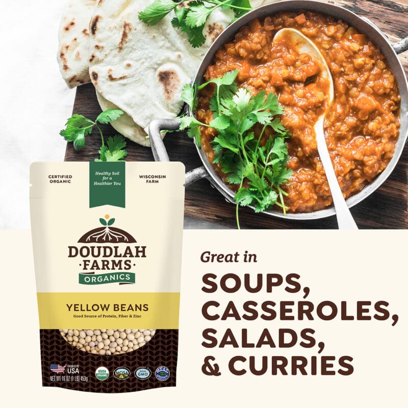 A package of Doulah Farms Organics Yellow Canary Beans sits beside a bowl of bean curry garnished with cilantro. Text highlights the 1LB beans as great for soups, casseroles, salads, and curries. A piece of flatbread is seen in the background.