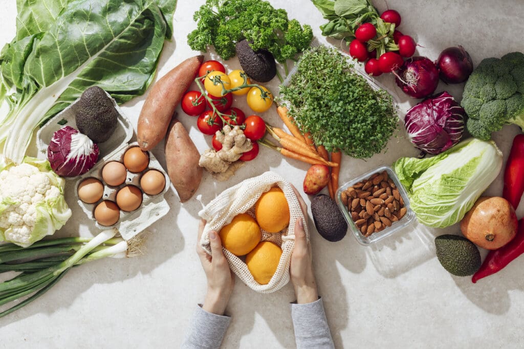 Fresh local organic produce and sustainable food choices including vegetables, fruits, and plant-based proteins that reduce carbon footprint