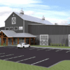 A modern barn-style building with gray metal siding, large barn doors, and wooden entryway accents, sits beside a parking lot with a few cars on a partly cloudy day. Green trees and grass surround the area.