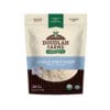 A pouch of Spelt Flour with a clear window displays the flour inside. The packaging, in blue and beige, showcases certifications such as USDA Organic and Non-GMO.