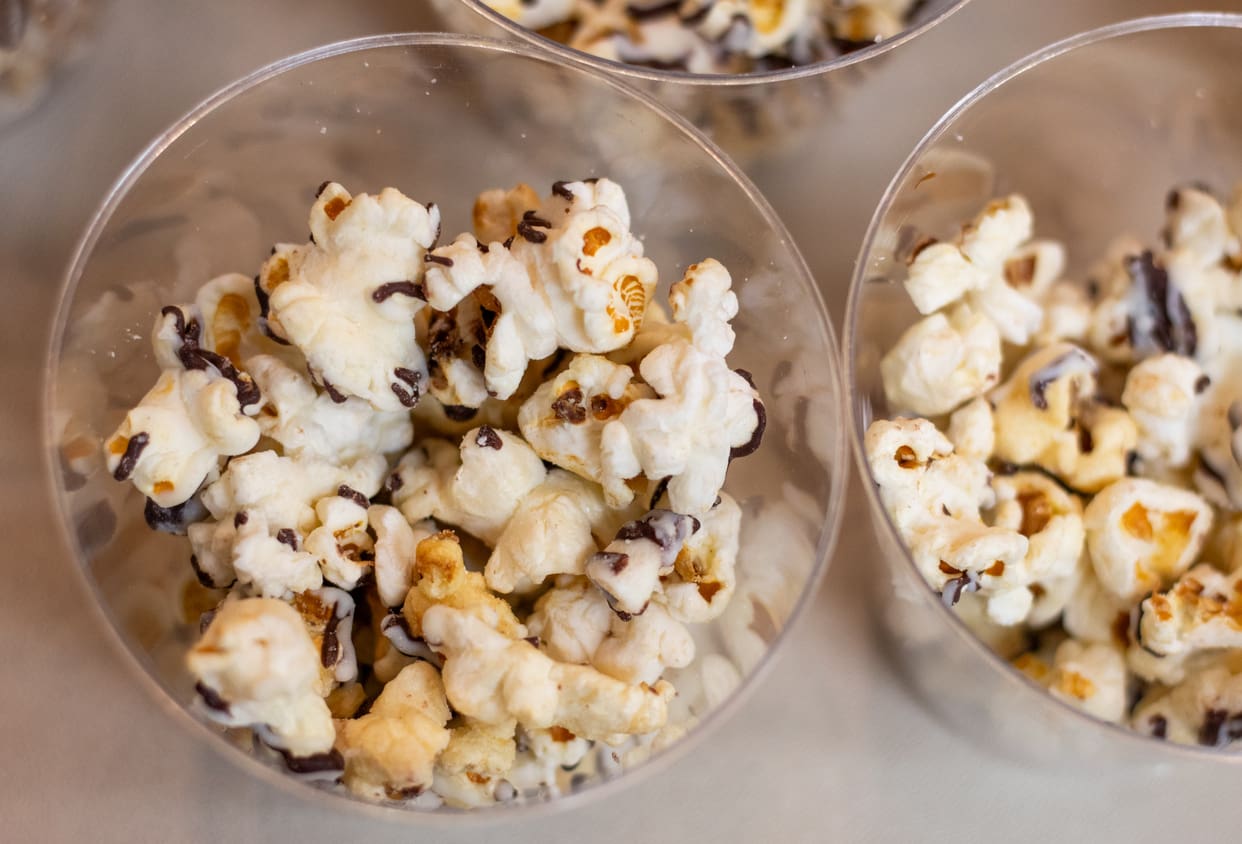 Chocolate covered popcorn in a cup on a tray