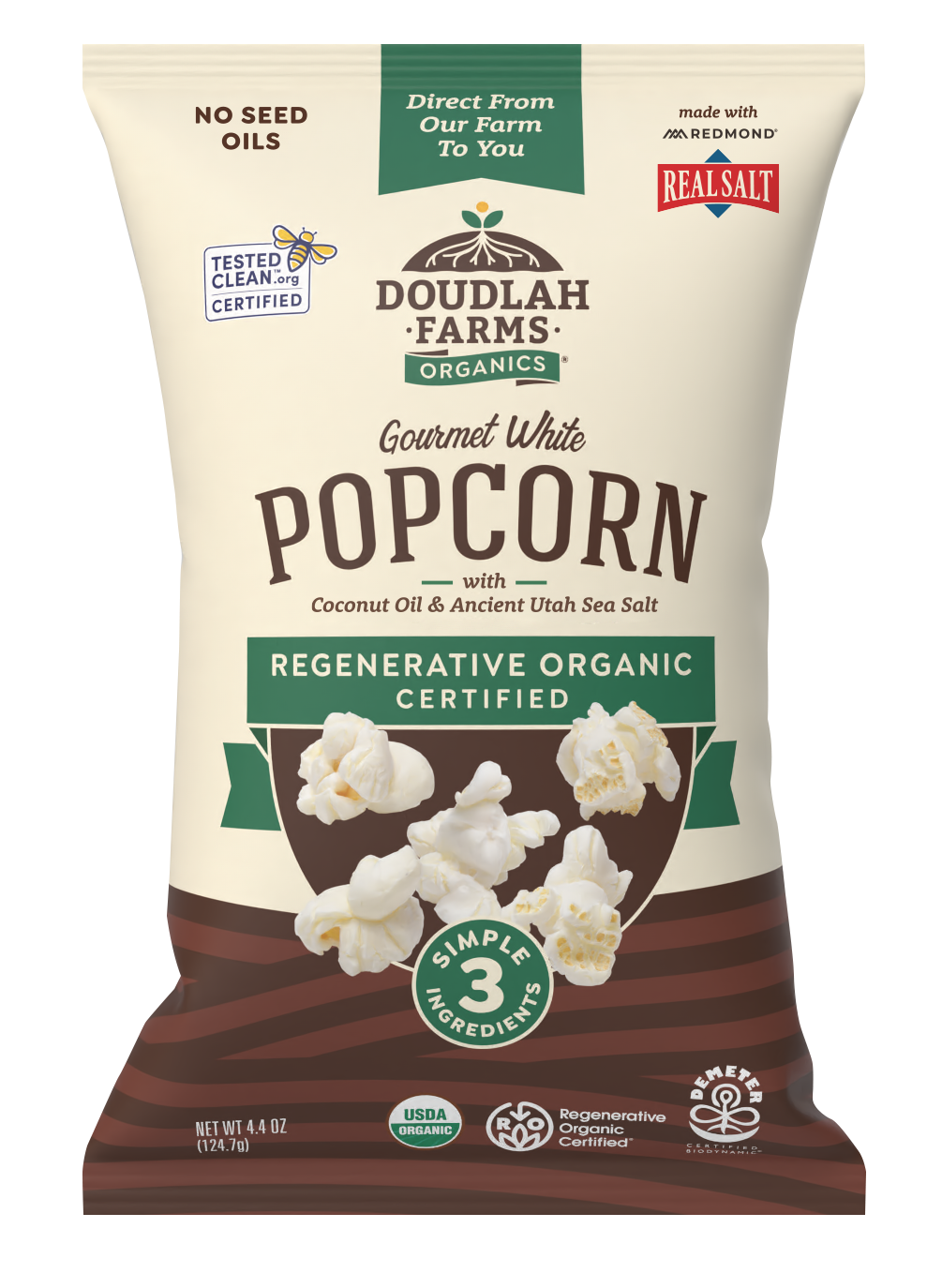 A bag of Popped Popcorn from Doudlah Farms Organics, made with coconut oil and Utah sea salt, bearing the Regenerative Organic Certified label and displaying popcorn images along with multiple certification badges on the front.