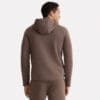 A man facing away from the camera wears a matching brown Premium Hooded Jacket and sweatpants set.