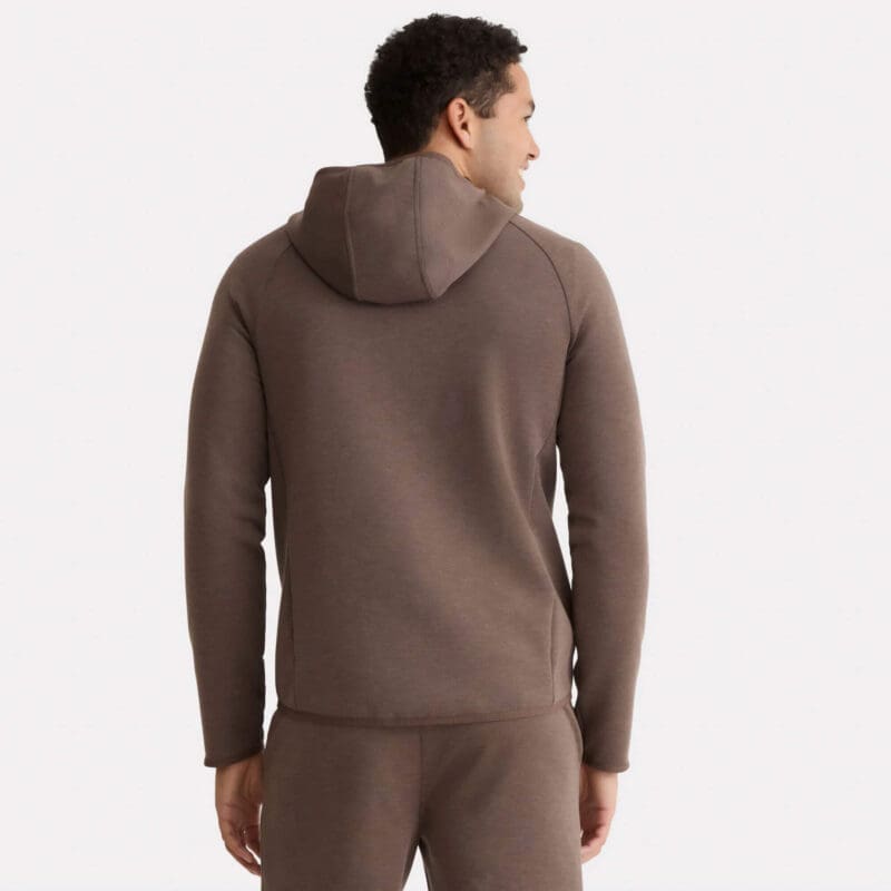 A man facing away from the camera wears a matching brown Premium Hooded Jacket and sweatpants set.